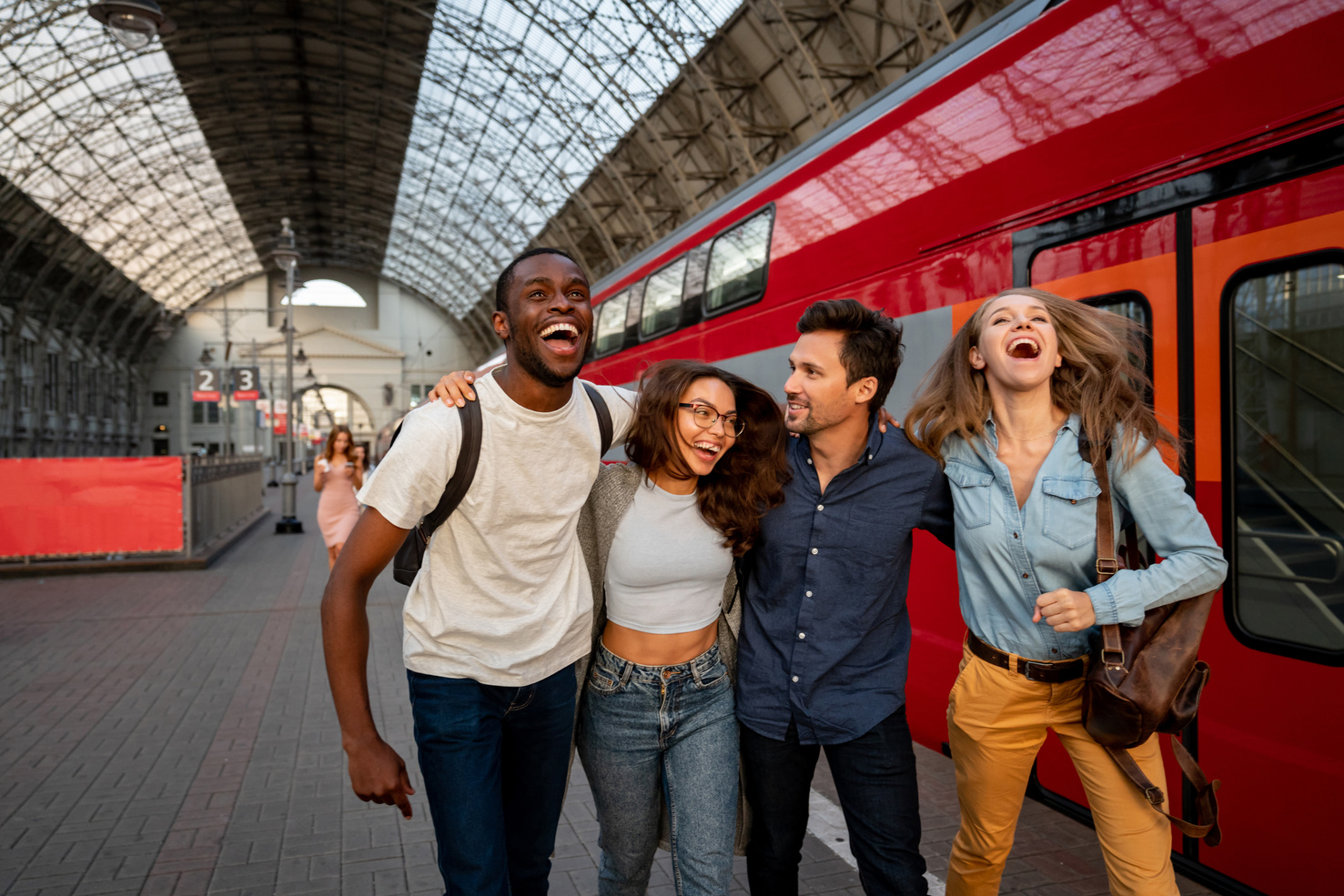 Happy group of friends traveling by train